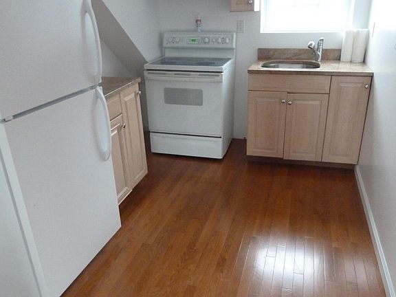 Efficient kitchen with full size fridge, oven, and microwave.