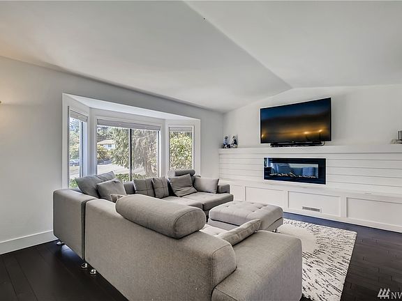 Raised ceilings in living room add additional dimension to this home. Large bay windows flood the space with natural light.
