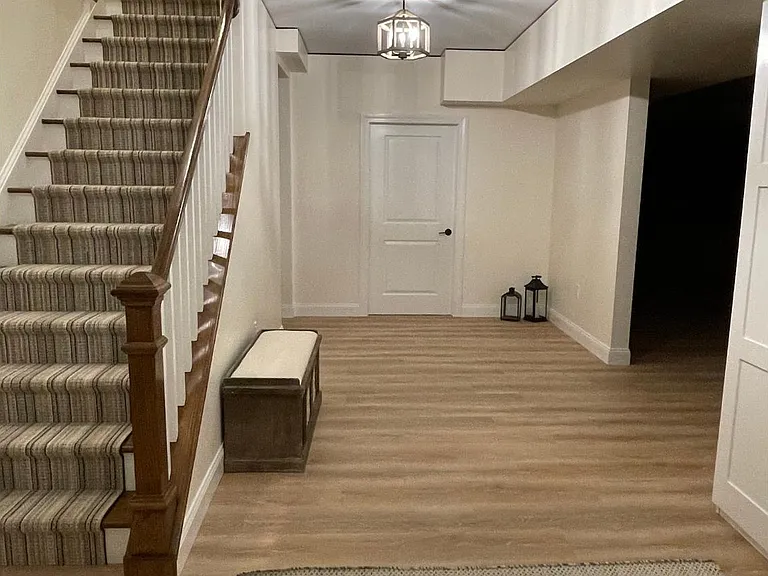 Entrance from garage with wine storage room, rec room, bonus fridge/freezer