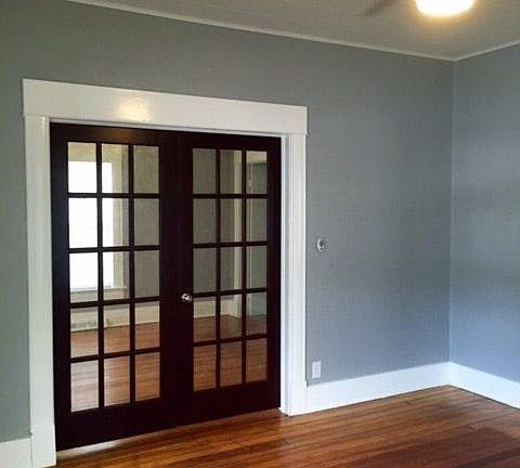 french doors to first bedroom from living room