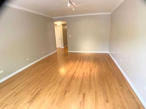 Living room 16-6 x 13-0 and large Bay Windows and hardwood flooring.