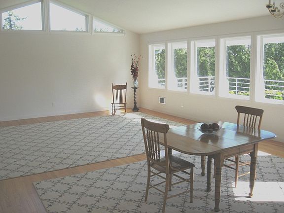 The Living and Dining space is Open with an abundance of windows overlooking the large deck creating