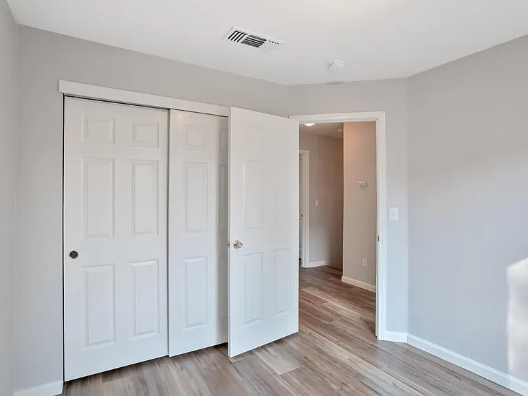 The view of one of the upstairs bedroom's closet & doorway.
