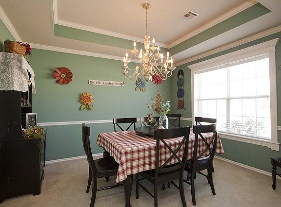 Great dining room with carpet and chandelier 
