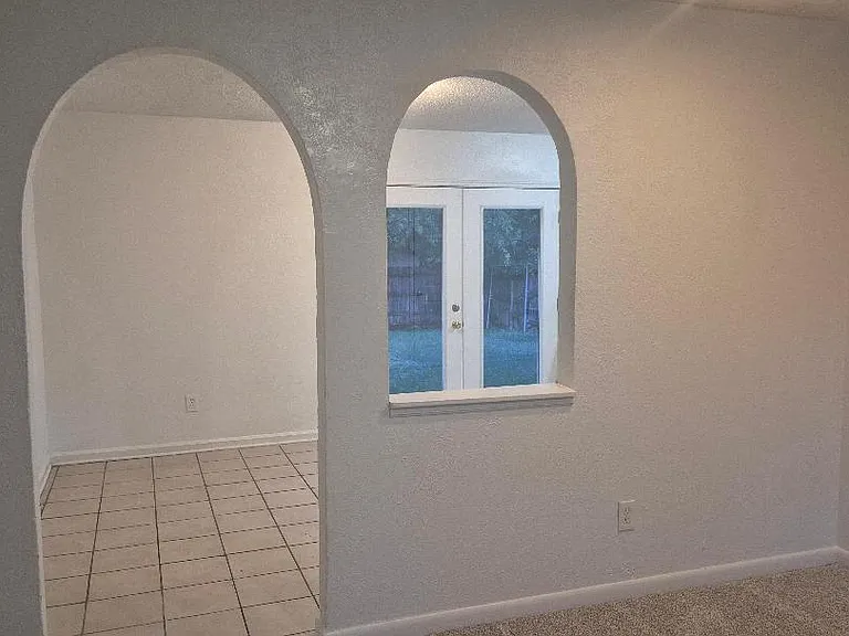 Decorative arches leading to kitchen area