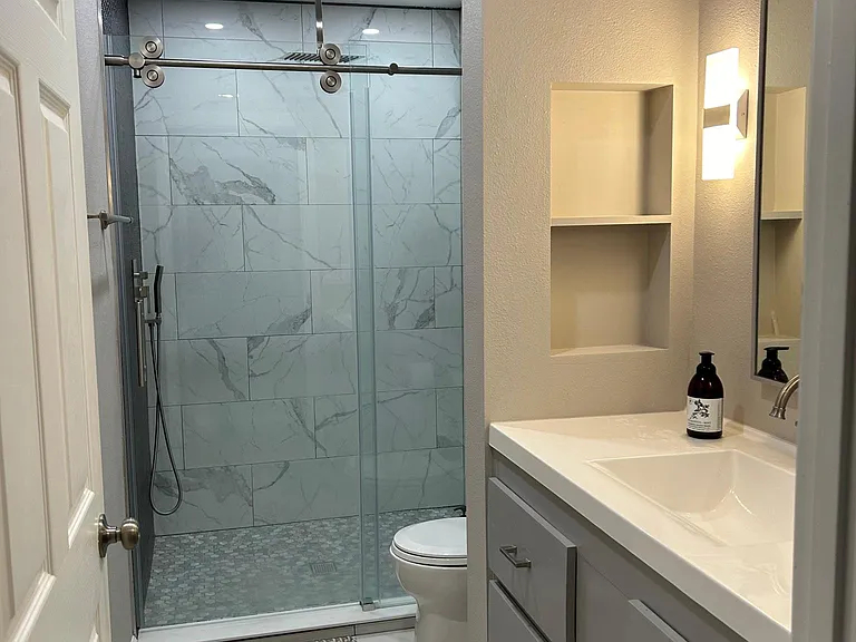 Newly remodeled bathroom with waterfall shower.