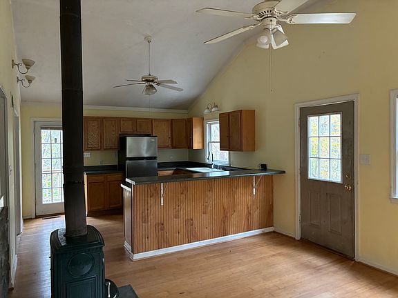 From living room looking at kitchen and entry door.