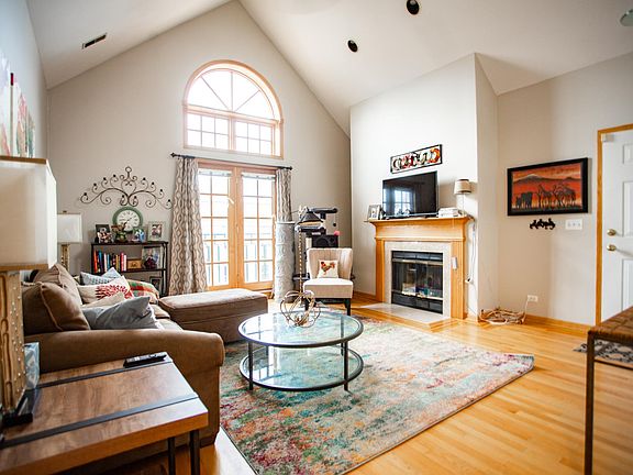 Living room w/wood burning fireplace and 11 foot ceilings