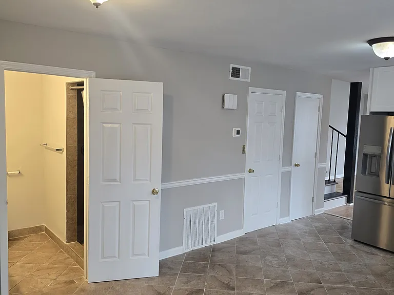 Kitchen with a view of the downstairs bathroom. Next 2 doors are the laundry room and pantry