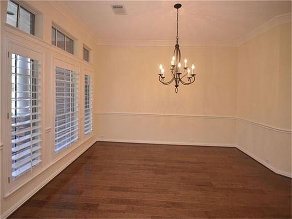 The Dining Room with Plantation Shutters and Hardwood Floors.