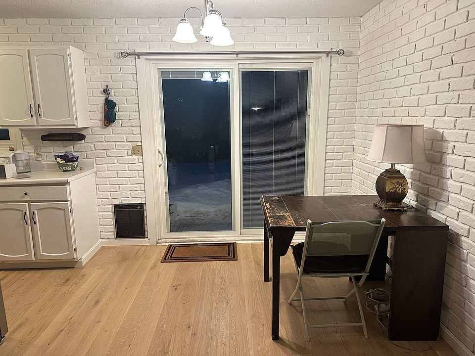 Back door which opens to pathway to driveway and carport. Kitchen to side