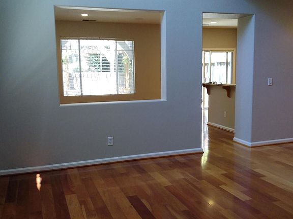 Living room - Cherry Hardwood Flooring - Wood Blinds throughout