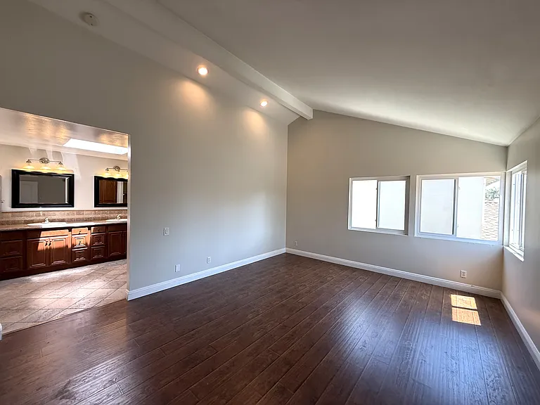 Primary bedroom with view of bathroom.