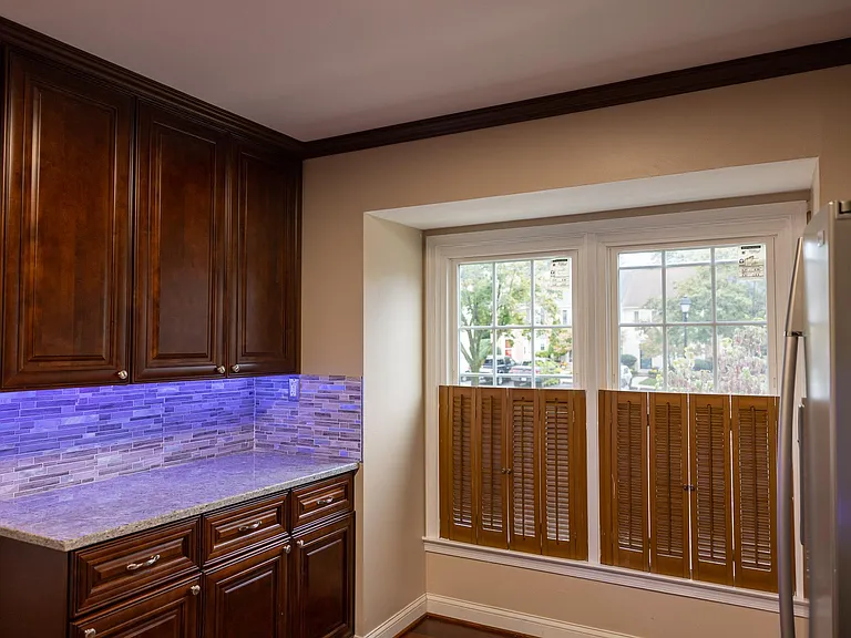 kitchen has under cabinet customizable colored led lights.