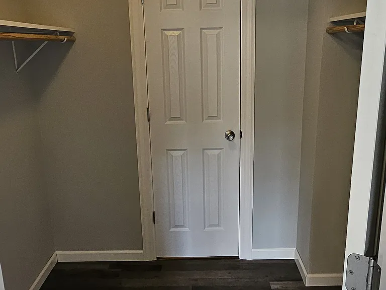 Master bedroom walk in closet that leads to bathroom.