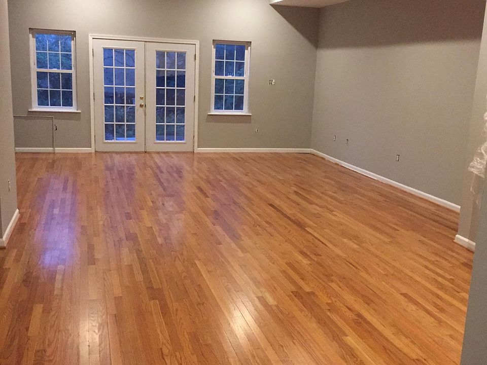 Open plan living room with French doors to backyard