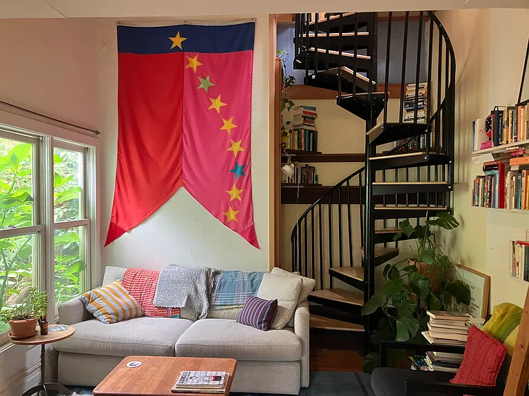 Looking into living room from sunroom. Stairs lead to bedroom with giant skylight and dormers looking north and south.