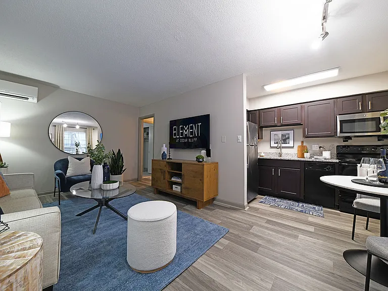 Experience the elegance and comfort of this stylish modern apartment, blending cozy living space with a sleek kitchen.