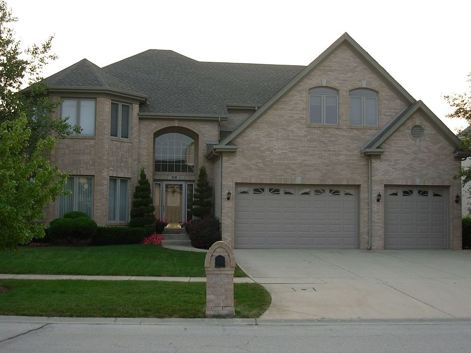 Front view, all brick, 3 car garage, corner oversized lot.