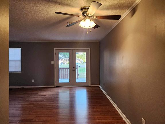 Large living and dining area with new French doors, hardwood flooring and new paint and blinds