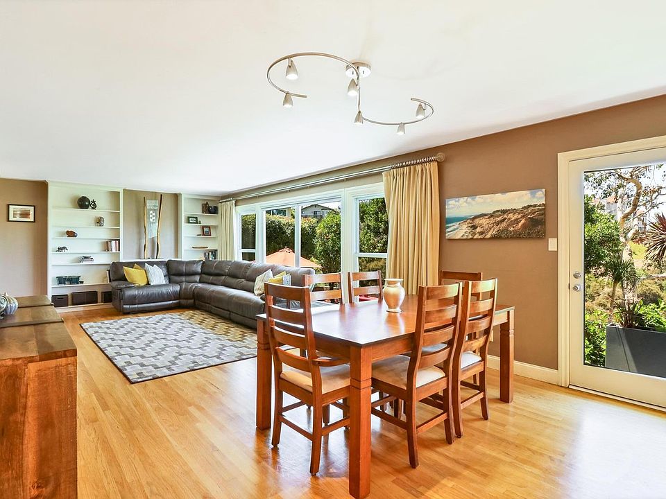 Spacious Great Room includes living room with floor to ceiling picture windows and full glass garden door to access backyard from dining area.