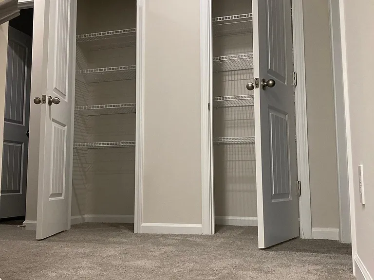 Upstairs foyer showing two extra closets at top of stairs.