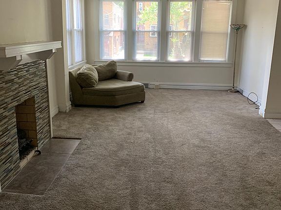 Living room with fireplace and large wall of windows