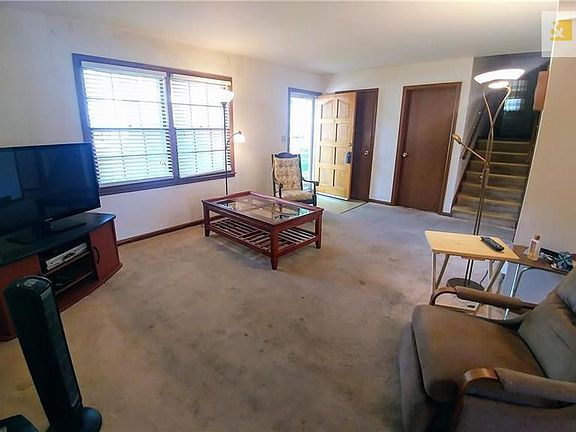 Large living room will need new carpet but there are hardwoods under the carpet if you prefer that.
