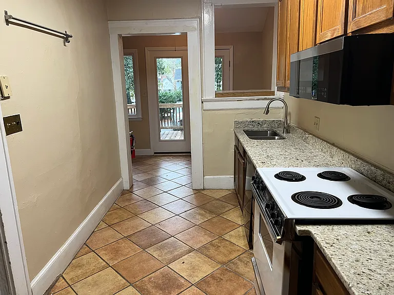 Kitchen with view of the deck and entrance area off the deck into the kitchen.