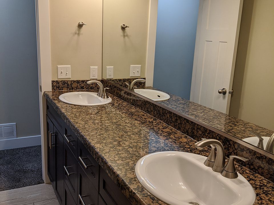 double sinks in bath with granite counter top.