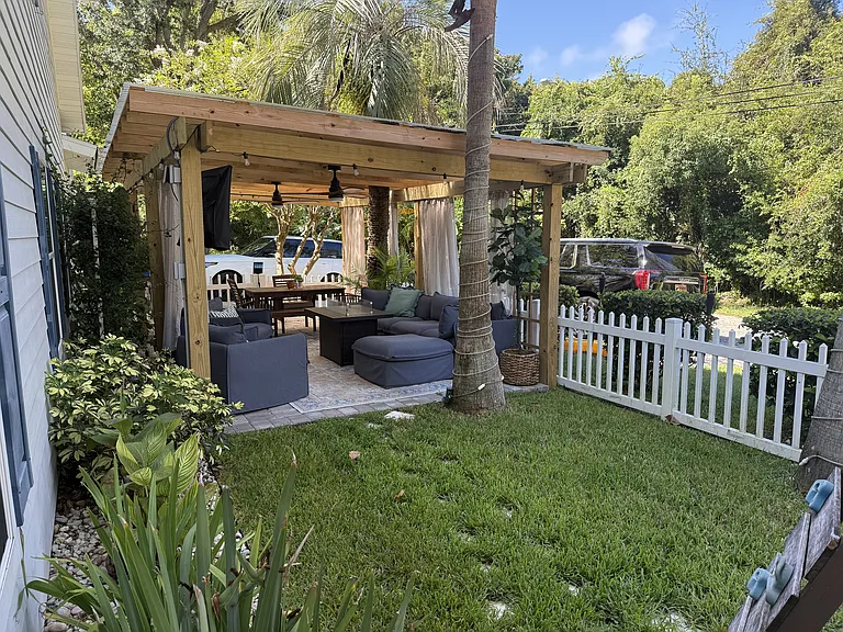 Side yard with custom covered pergola with fans