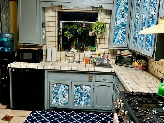 Kitchen with new paint and stainless stove and dishwasher