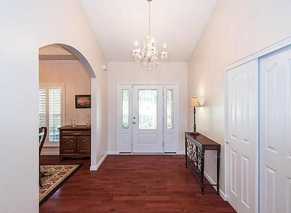 A view from within the Main Entry to the Decorative Glass Door System.  The eased eyebrow arched opening softens the lines to the elegant Dining Space.
