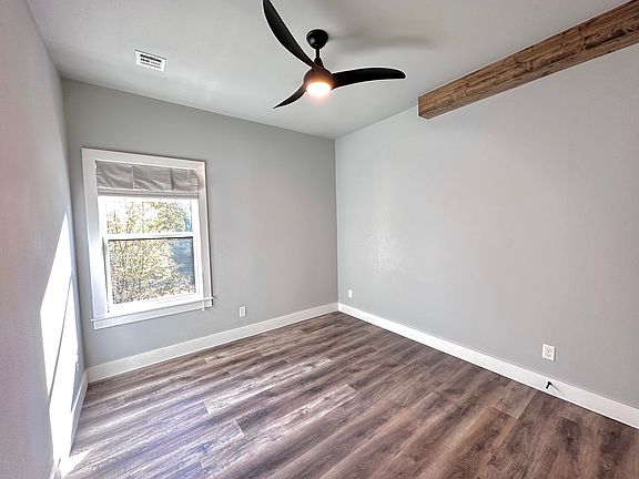 Enjoy tranquil views of the property's mature trees, complemented by designer Roman shades for privacy and style. Call or text for a tour today!