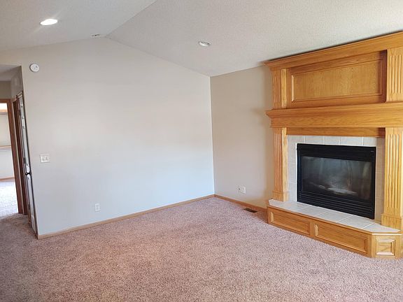 Living room with vaulted ceiling and gas fireplace