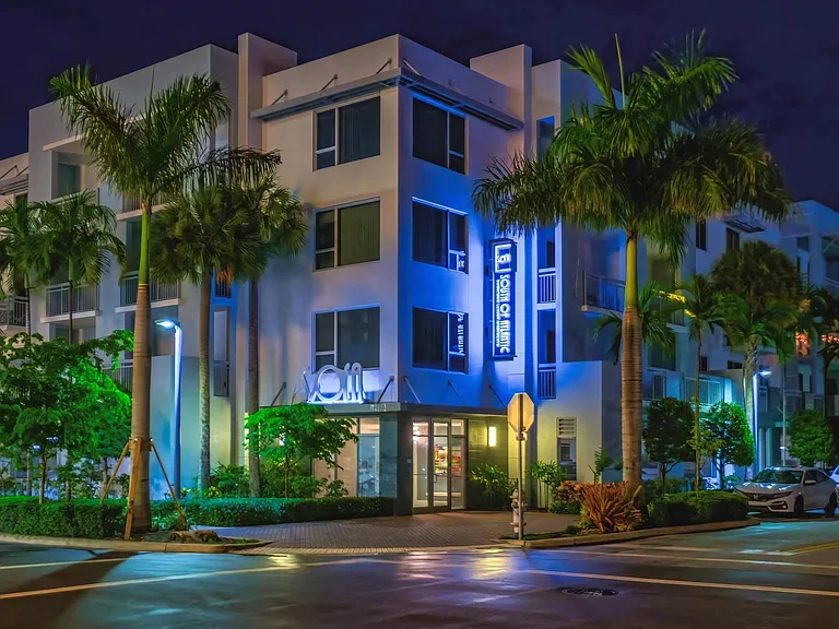Evening View of South of Atlantic Luxury Apartments with Vibrant Blue Accent Lighting