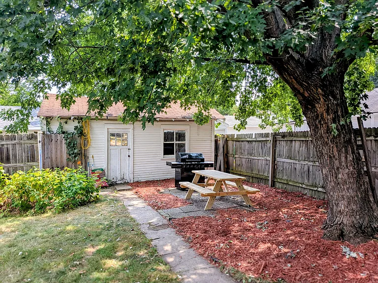 Picnic table and Grill in backyard. Included in rent