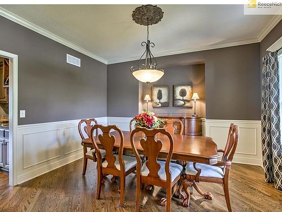 Formal dining room with hardwood floors, wainscoting, built in niche, and butler's pantry!