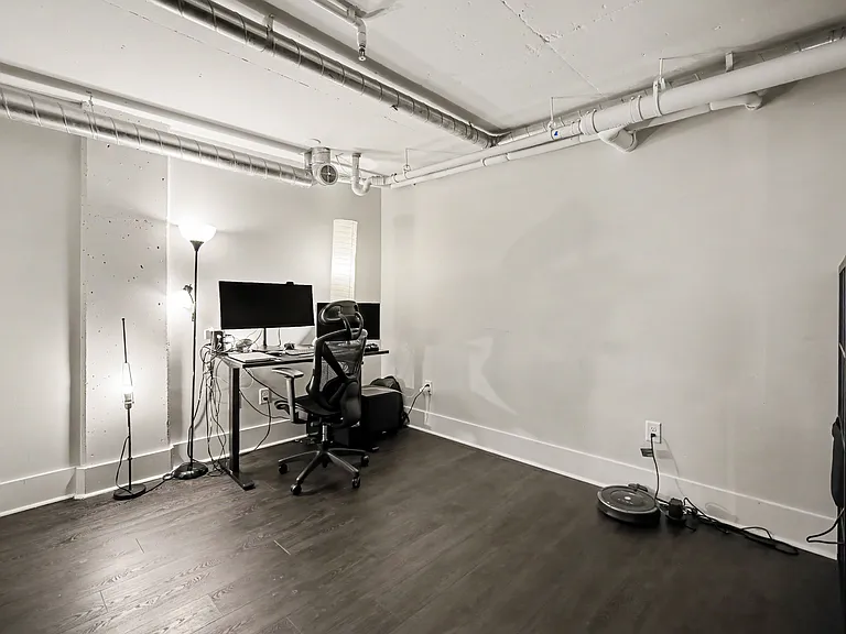 Second bedroom in the unit has is a perfect home office nook, two screen ready for your use, ergonomic chair and table that can raise to standing table height