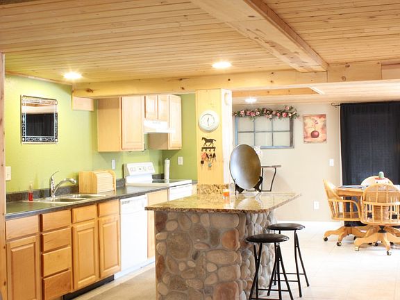 The kitchen includes tile floors and knotty pine ceiling.