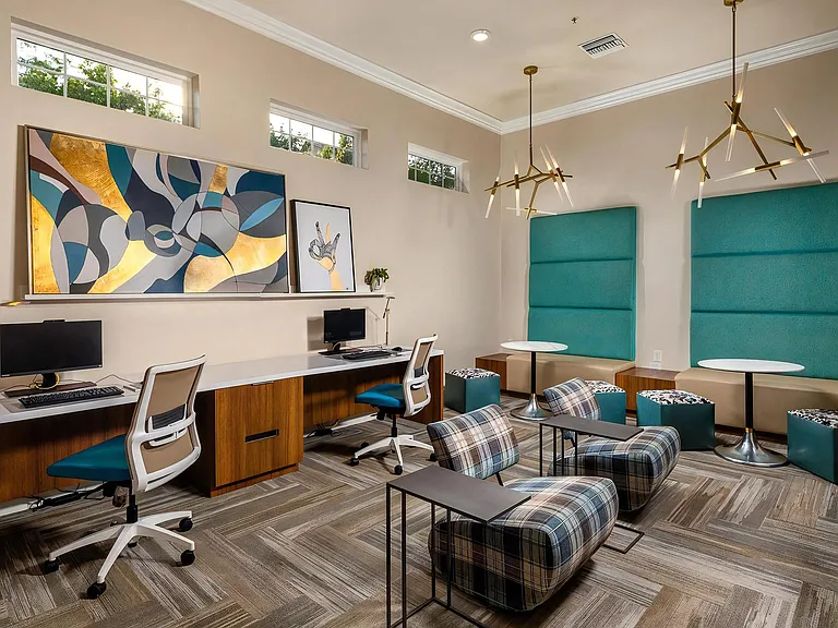 Stylish Resident Lounge Featuring Desks, Lounge Chairs, And Booths