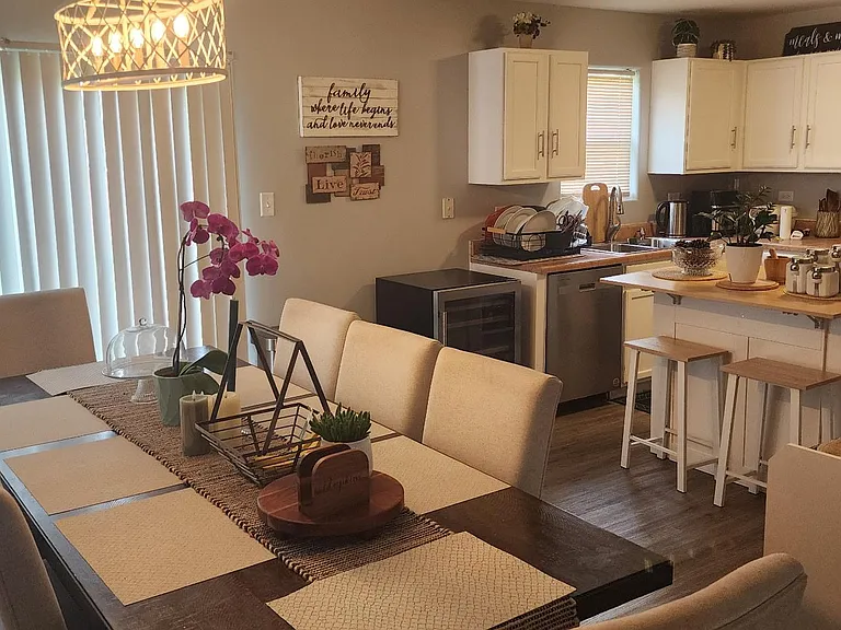 Open kitchen and dining area with island seating, ample cabinetry, and a full appliance package for everyday cooking.