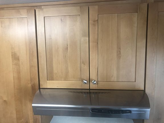 modern kitchen cabinets and high flow stove vent hood.