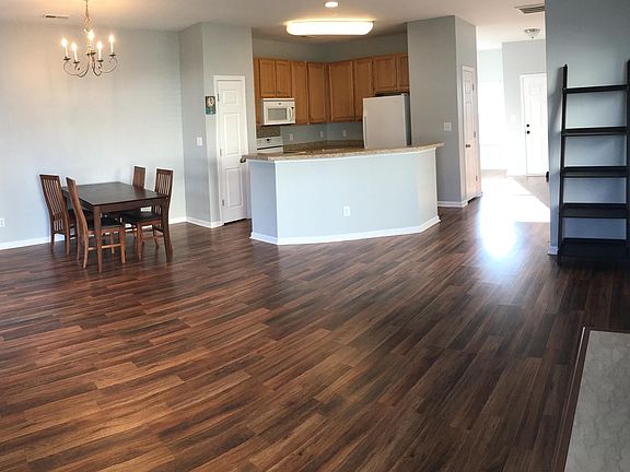 in front of kitchen is a bar top, which fits 3 comfortably