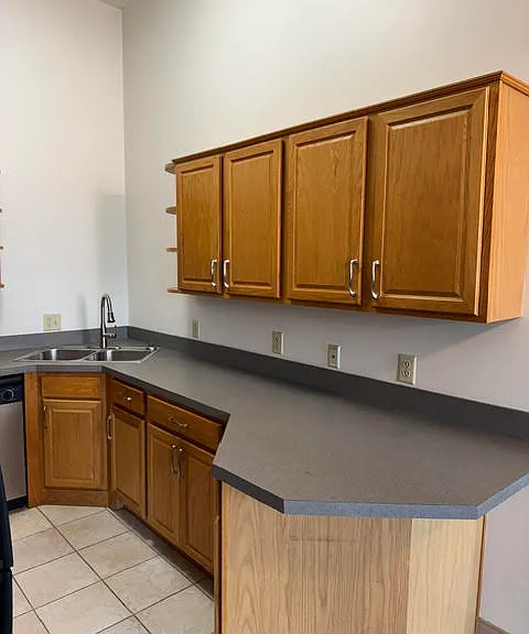 Large kitchen with lots of cabinets.