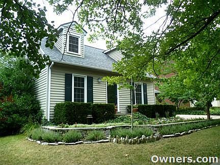 Front of house, with 2-car, attached garage on opposite side.