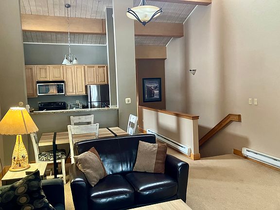 View of kitchen and dining area from living room. Steps to first floor