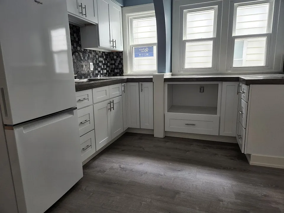 Kitchen. New windows, cabinetry, flooring, counter tops, fridge, microwave shelf
