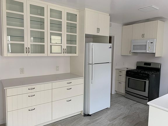 Kitchen, south wall. All new cabinets, built-in microwave.