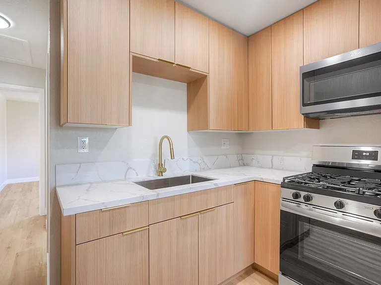 Flat Euro cabinets with designer handles and stainless steel appliances